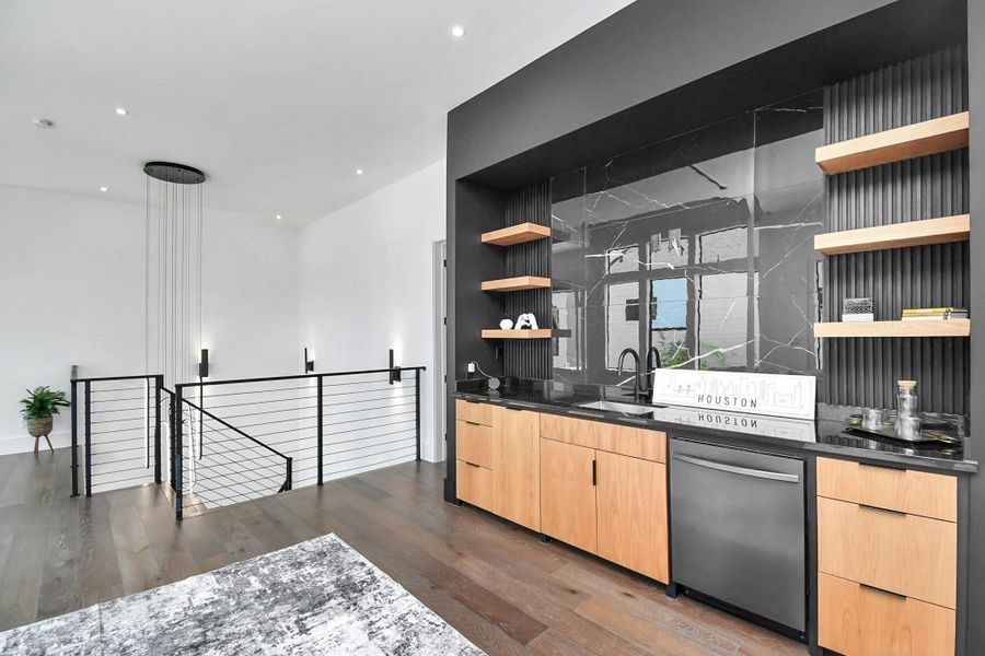Wet bar features European cabinetry, dishwasher, and sink. Wet bar features European cabinetry, dishwasher, and sink.
