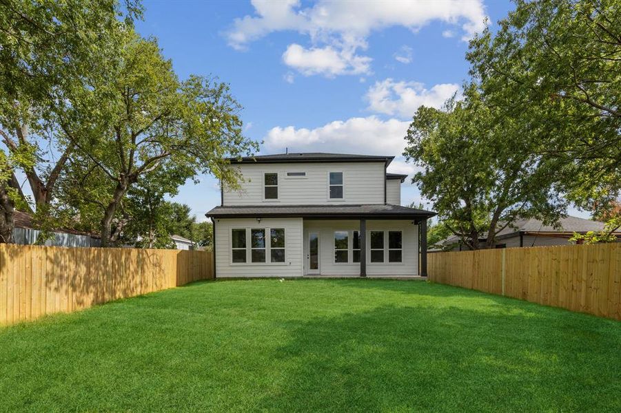 Back of house with a lawn