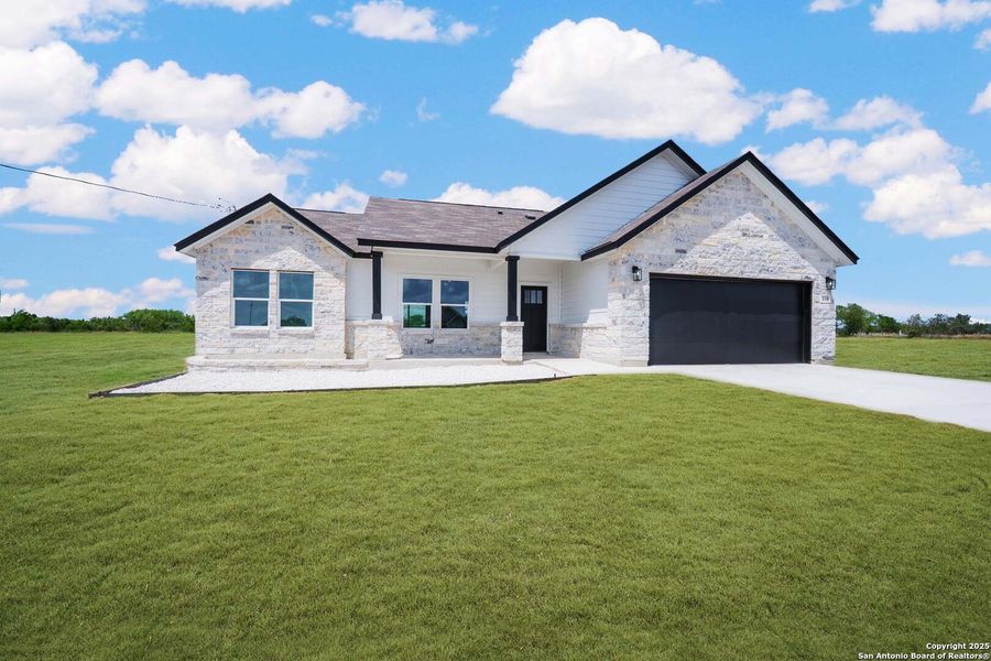 Front exterior of a new home in , Natalia, TX, highlighting curb appeal (Image 2). Front exterior of a new home in , Natalia, TX, highlighting curb appeal (Image 2).