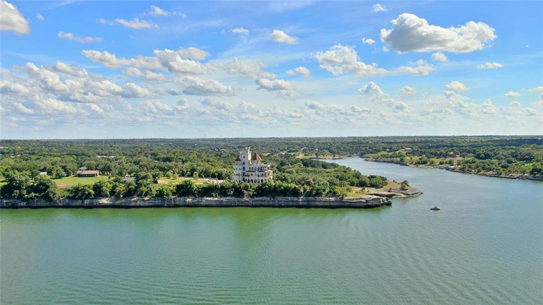 Birds eye view of property featuring a water view and a view of trees