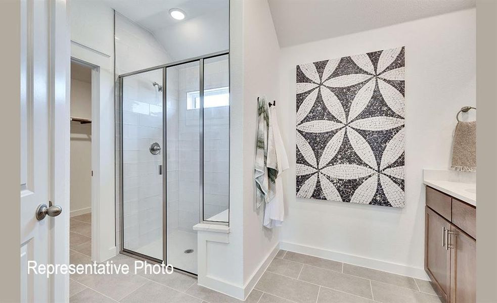 Modern bathroom featuring a glass-enclosed shower with subway tile surround and built-in bench