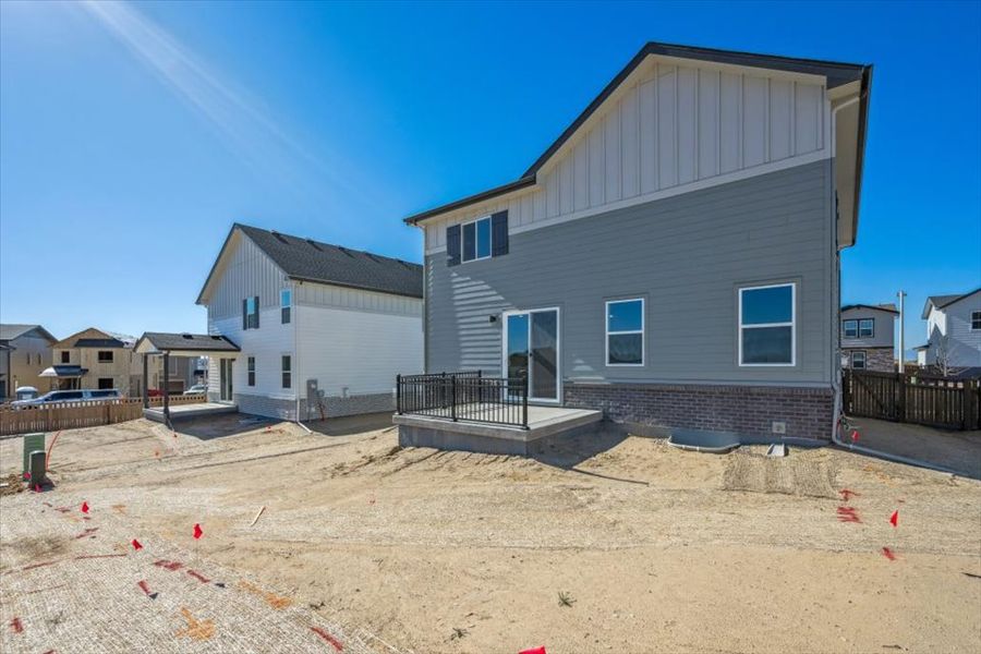 A house with a fence and sand.