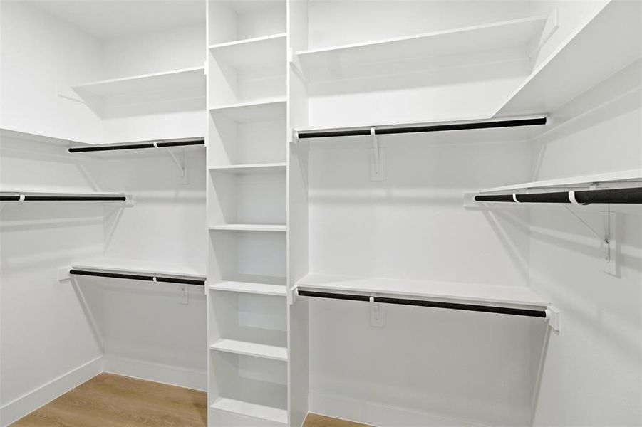 Walk in closet featuring light wood-style flooring