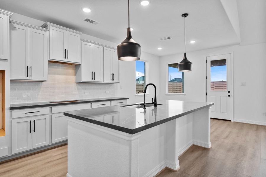 The kitchen channels city living with contemporary finishes, statement details, and space made for gathering. The kitchen channels city living with contemporary finishes, statement details, and space made for gathering.