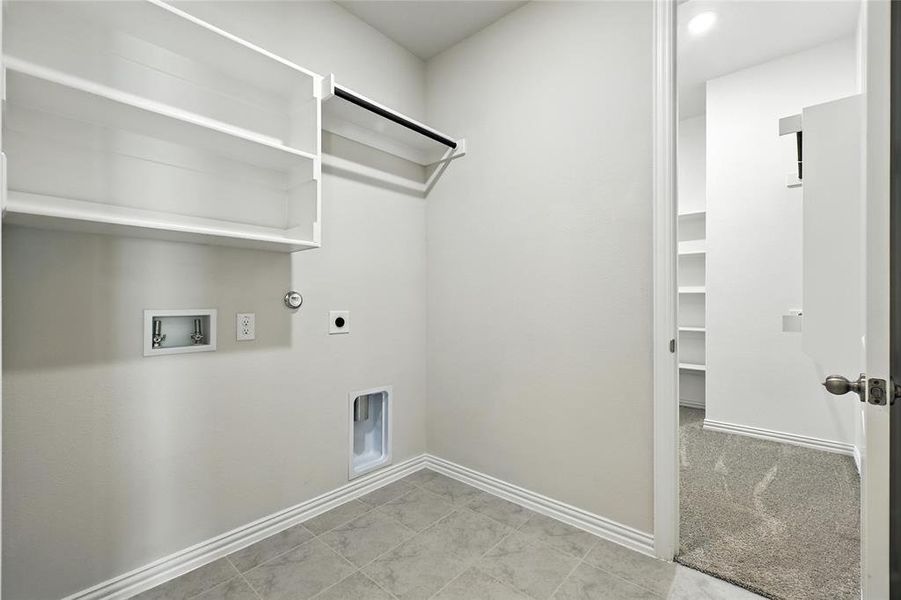 Laundry area featuring washer hookup, hookup for an electric dryer, hookup for a gas dryer, and light tile patterned floors