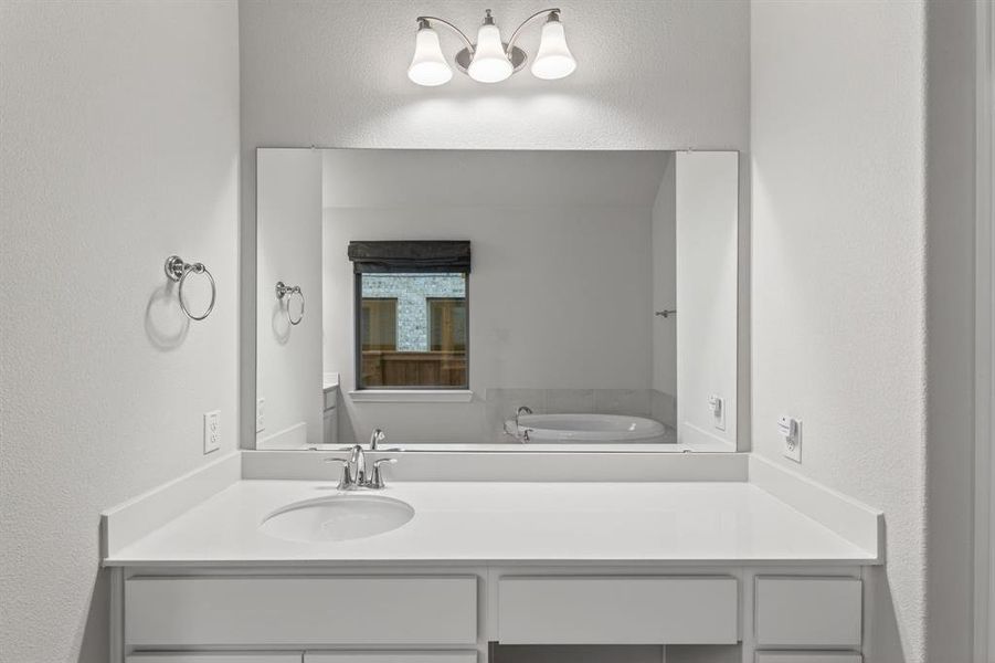 Bathroom with a textured wall and vanity Bathroom with a textured wall and vanity