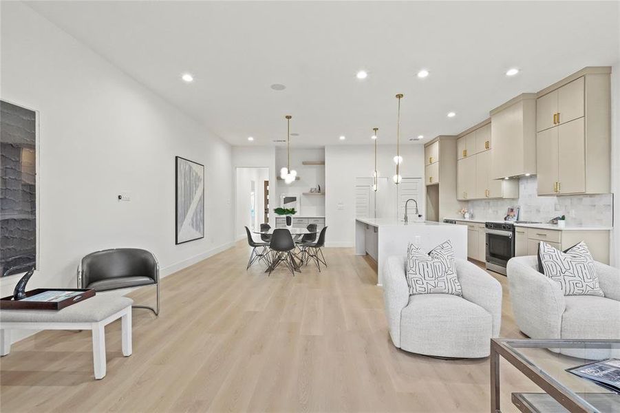 Living area with light wood-style floors and recessed lighting