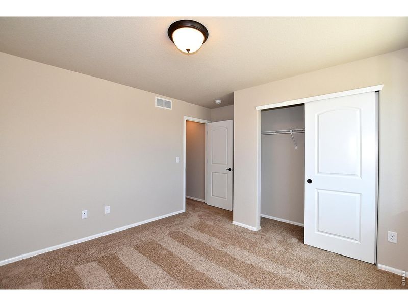 Spacious, unfurnished interior of a new home in Union Colony West, Greeley (Image 34).