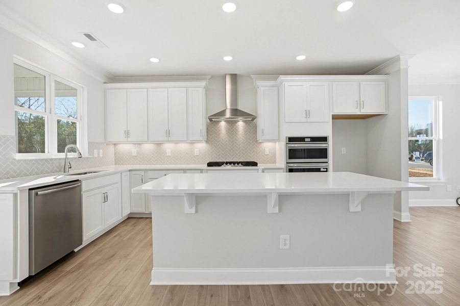 Kitchen with white quartz Countertops and white cabinets