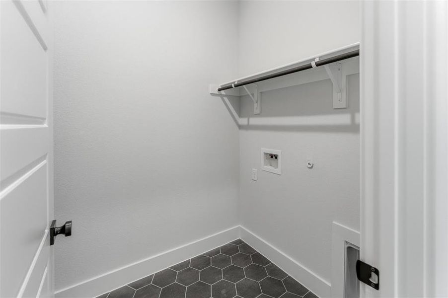 Laundry room featuring hookup for a gas dryer, washer hookup, and dark tile patterned flooring
