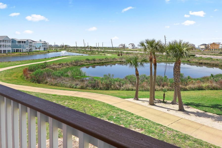 From the balcony, take in sweeping views of the Pointe West community, with lush landscaping and water features that enhance the coastal retreat experience.