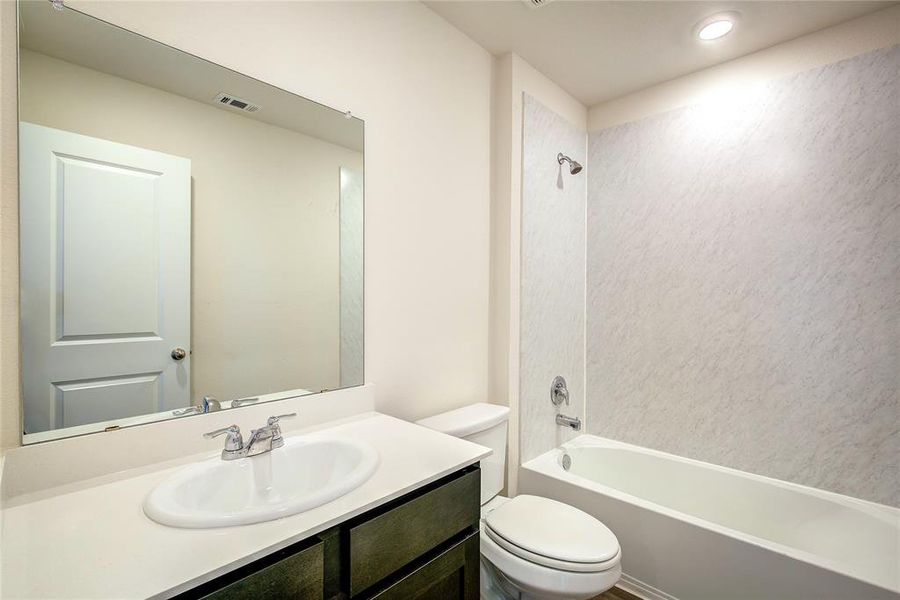 Bathroom with vanity and tub / shower combination
