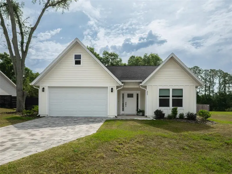 Front exterior of a new home in , Newberry, FL, highlighting curb appeal (Image 17).