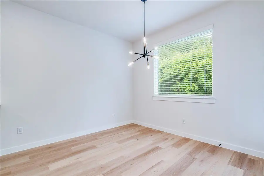 A well-lit room showcases modern design and durable wood-look flooring.