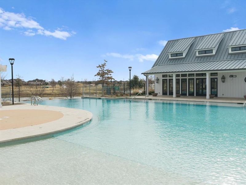 Community pool featuring a patio area and a sunroom