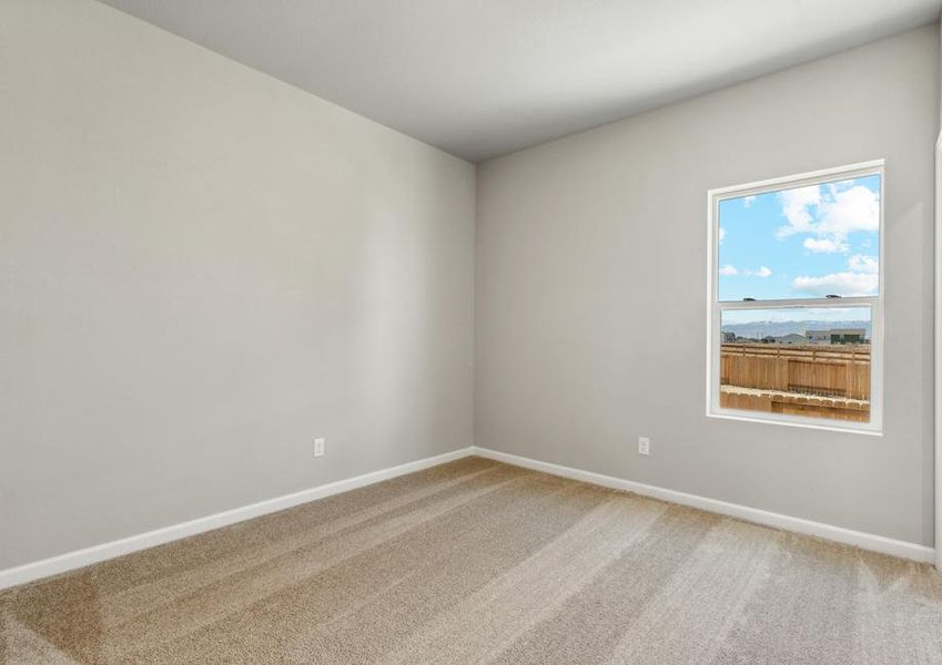 The master bedroom has a large window and carpet.