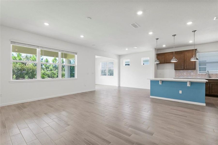 family to kitchen + lots of light from windows