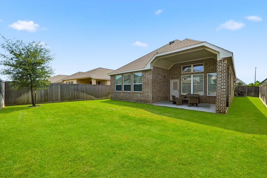 The fully fenced backyard offers a private, secure setting where pets can roam freely and enjoy the outdoors in comfort.