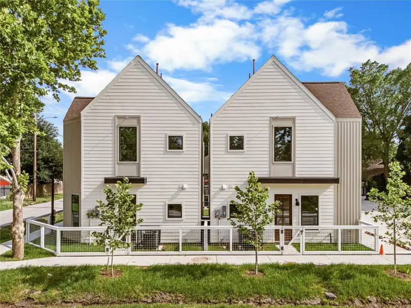 Perfectly symmetrical rear facades complete with young shade trees and neat fencing. Perfectly symmetrical rear facades complete with young shade trees and neat fencing.