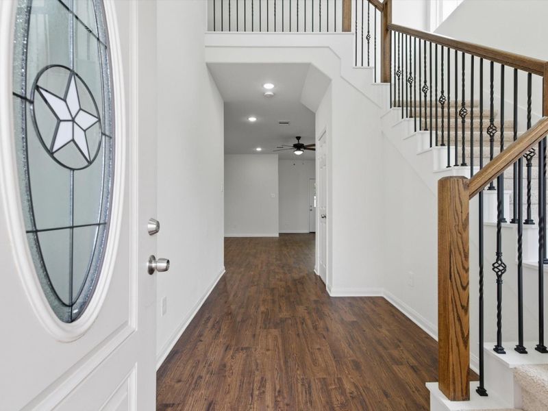 Step inside to soaring ceilings and sleek vinyl plank flooring that create an immediate sense of space, style, and durability from the moment you enter.