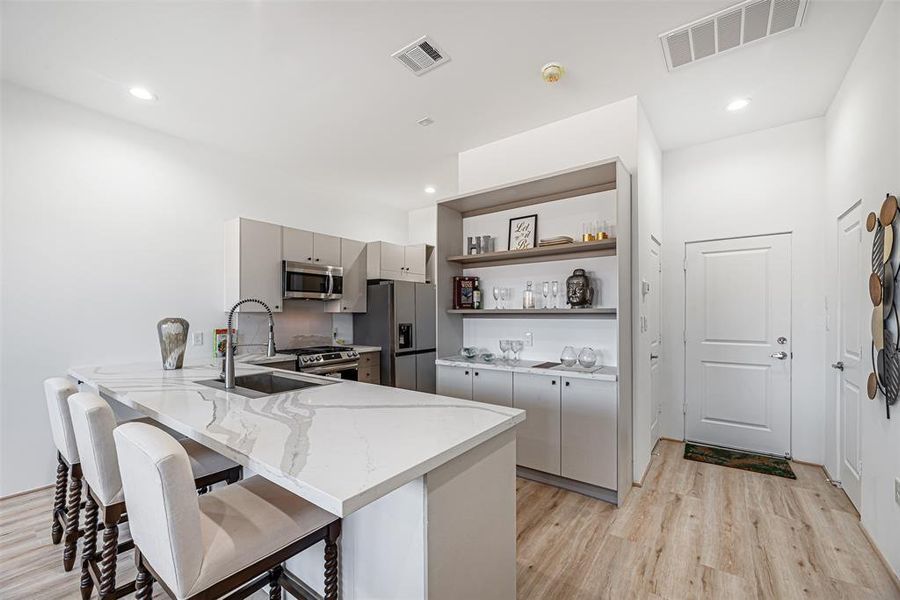 Kitchen has an open shelving nook for those who love to display their statement piece items.