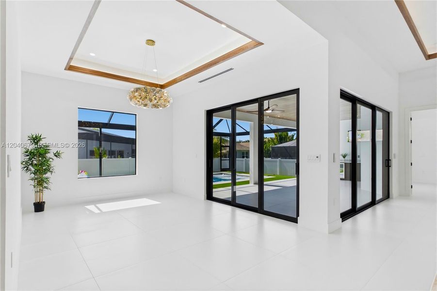 Host memorable dinners in the spacious formal dining room featuring stackable doors to lanai & large picture window overlooking the pool area