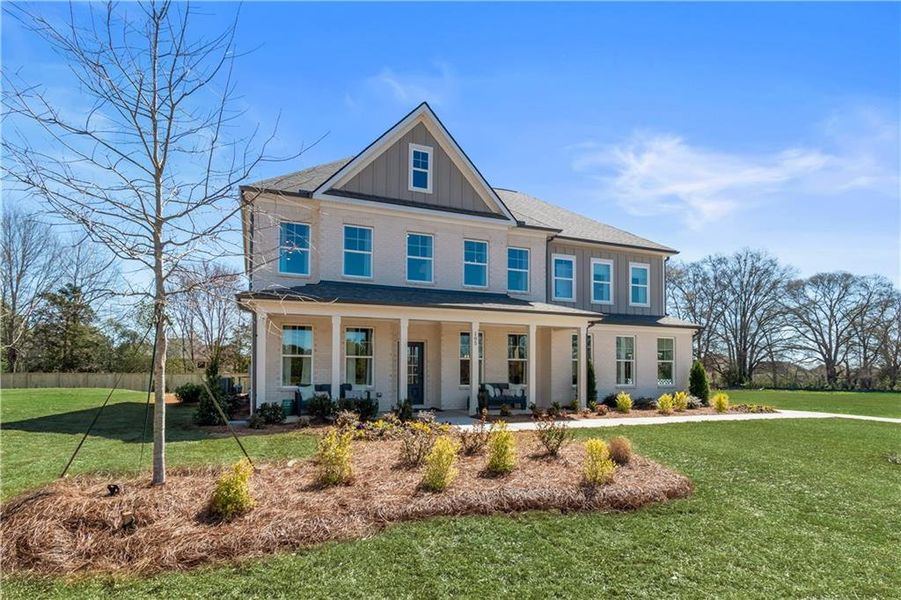 Front exterior of a new home in Cambria at Traditions, Hampton, GA, highlighting curb appeal (Image 21). Front exterior of a new home in Cambria at Traditions, Hampton, GA, highlighting curb appeal (Image 21).