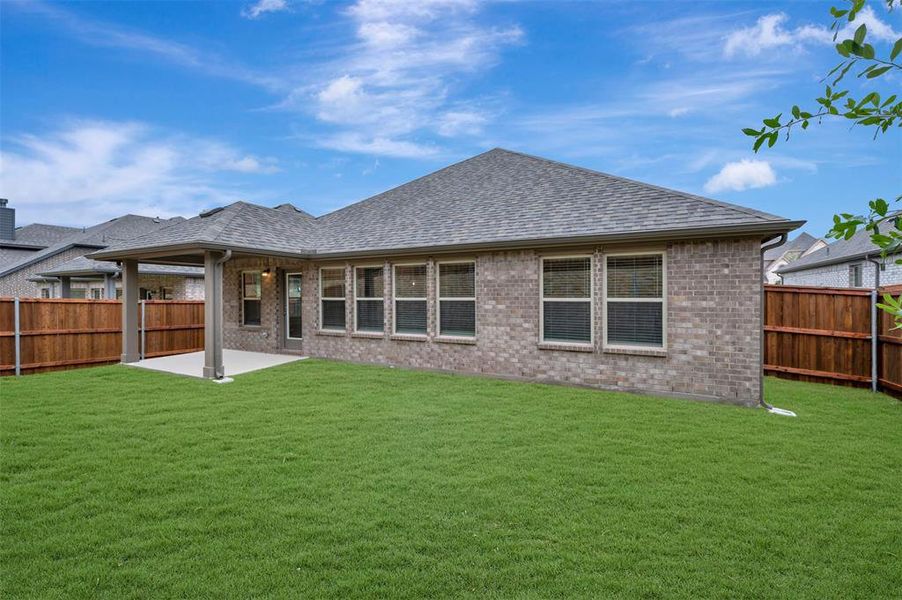 Exterior details and patio area of a home in Woodstone, Providence Village (Image 3).