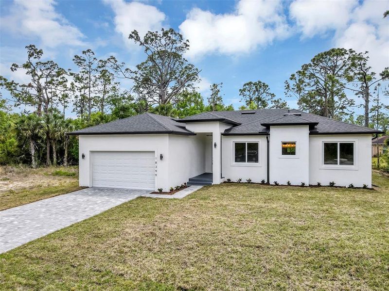 Front exterior of a new home in , Port Charlotte, FL, highlighting curb appeal (Image 24).