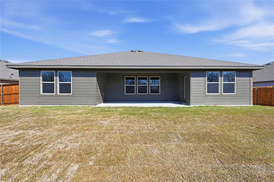 Rear exterior featuring gray horizontal siding, a covered patio, and a shingle roof Rear exterior featuring gray horizontal siding, a covered patio, and a shingle roof