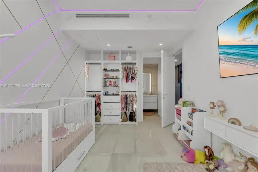 Custom built-in wardrobe with open shelving and integrated drawer storage, recessed LED accent lighting, and large-format tile flooring Custom built-in wardrobe with open shelving and integrated drawer storage, recessed LED accent lighting, and large-format tile flooring