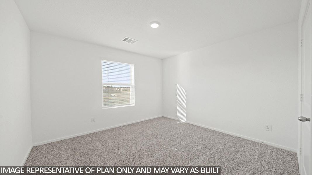 Bright interior space featuring light-colored carpet, a single window with horizontal blinds, recessed ceiling lighting, and a white interior door