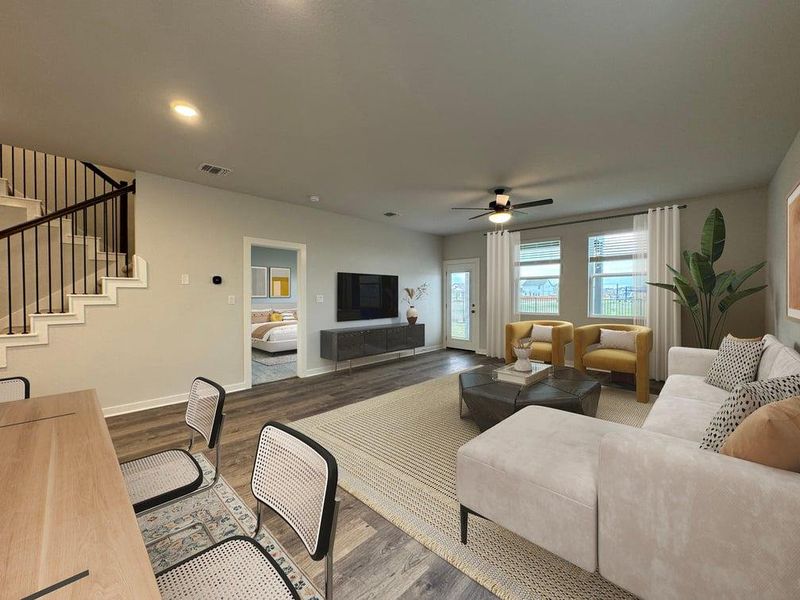 Gleaming hardwood floors and a modern staircase anchor this open and versatile living space.