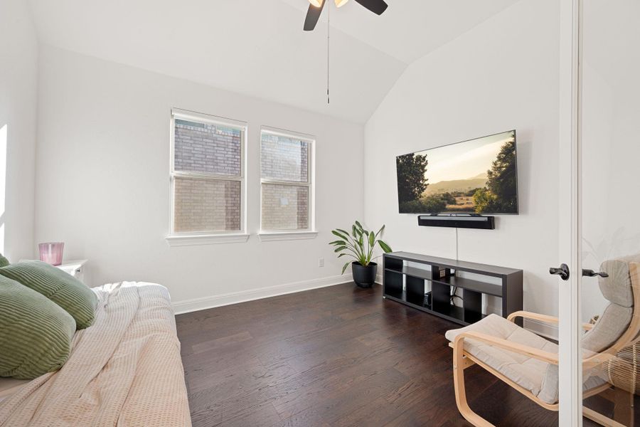A well-lit room featuring rich hard surfaced flooring and a vaulted ceiling with a fan. A well-lit room featuring rich hard surfaced flooring and a vaulted ceiling with a fan.