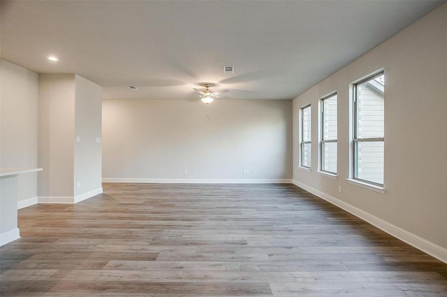 Spare room with ceiling fan and light wood-type flooring