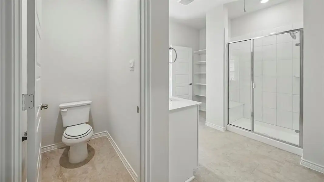 Spacious bathroom featuring a glass-enclosed shower with tiled walls and an integrated bench Spacious bathroom featuring a glass-enclosed shower with tiled walls and an integrated bench