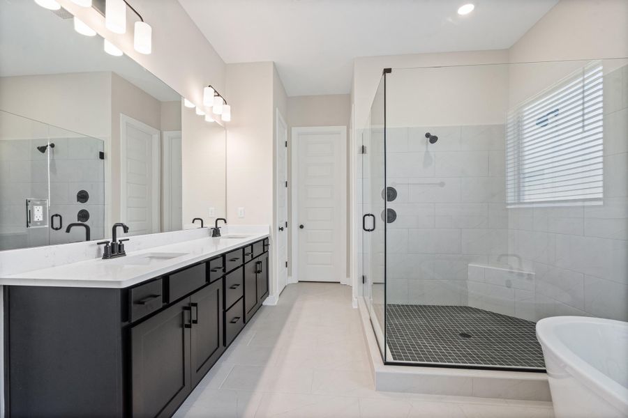 Modern bathroom featuring a dual vanity with dark cabinetry and white countertops Modern bathroom featuring a dual vanity with dark cabinetry and white countertops