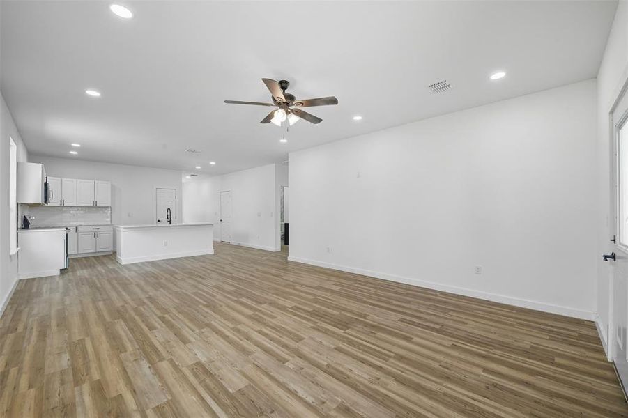Unfurnished living room featuring recessed lighting, light wood-style flooring, and ceiling fan Unfurnished living room featuring recessed lighting, light wood-style flooring, and ceiling fan