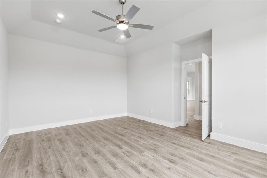 Empty room with light wood-style floors and ceiling fan Empty room with light wood-style floors and ceiling fan