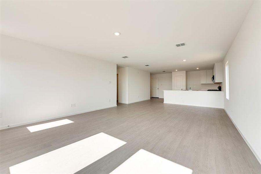 Unfurnished living room with recessed lighting and light wood-type flooring Unfurnished living room with recessed lighting and light wood-type flooring
