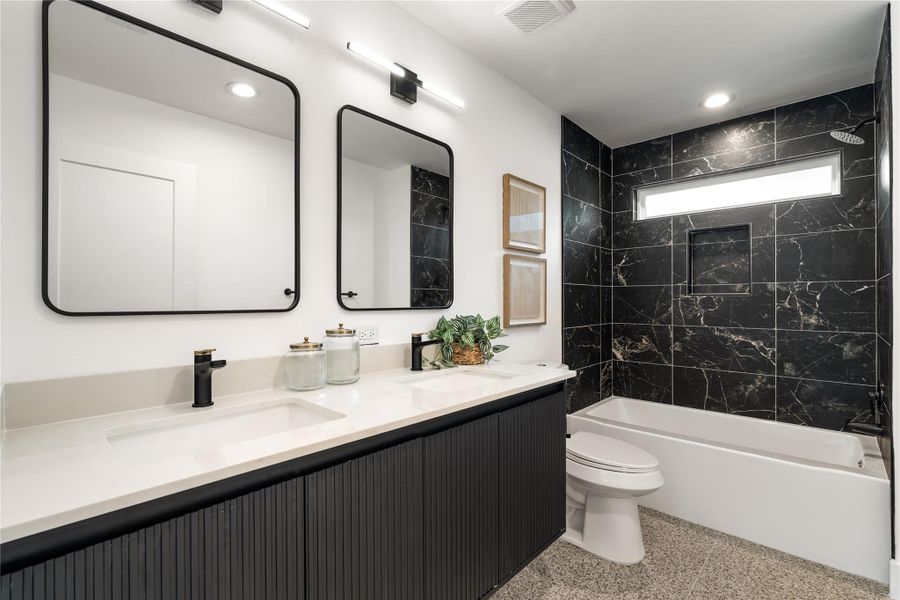 Morning routines are a little easier with dual sinks, generous counter space, and a soaking tub wrapped in dramatic floor-to-ceiling tile. Morning routines are a little easier with dual sinks, generous counter space, and a soaking tub wrapped in dramatic floor-to-ceiling tile.