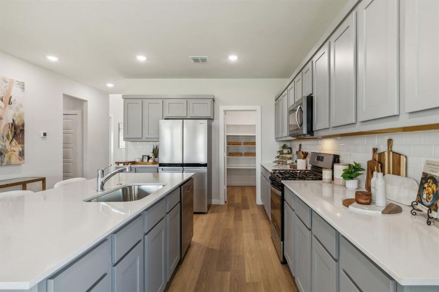 Kitchen in the Winters home plan by Trophy Signature Homes  REPRESENTATIVE PHOTO