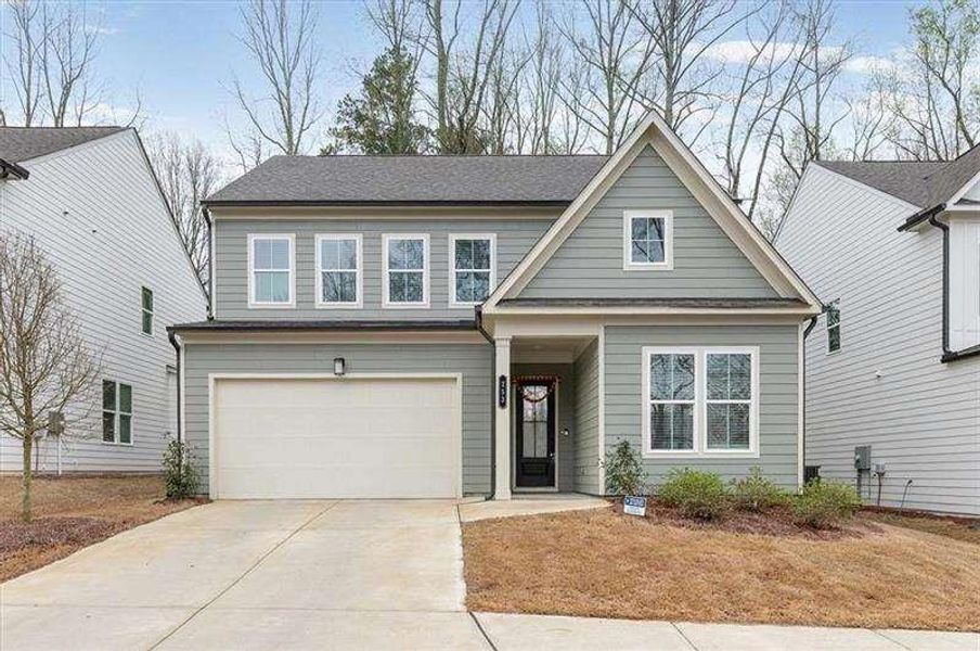 Front exterior of a new home in Enclave at Edgewater, Holly Springs, GA, highlighting curb appeal (Image 26). Front exterior of a new home in Enclave at Edgewater, Holly Springs, GA, highlighting curb appeal (Image 26).