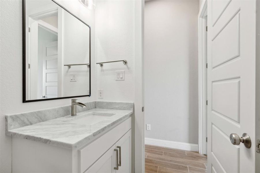 Bathroom with hardwood / wood-style floors and vanity