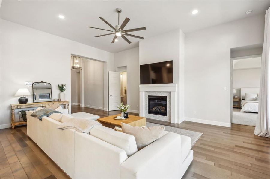 Living room featuring ceiling fan and hardwood / wood-style floors