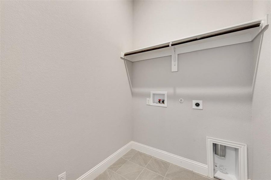 Laundry area with gas dryer hookup, washer hookup, and electric dryer hookup Laundry area with gas dryer hookup, washer hookup, and electric dryer hookup