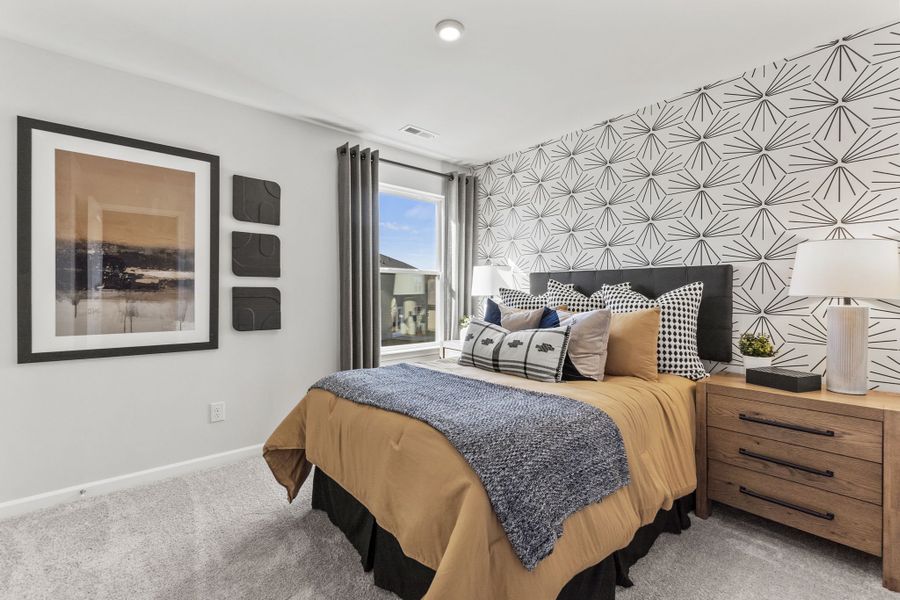 A bedroom with a bed and a window.