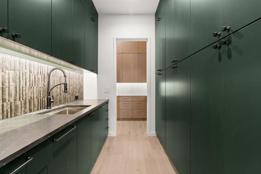 This butler's pantry includes another dishwasher, sink and plenty of storage.