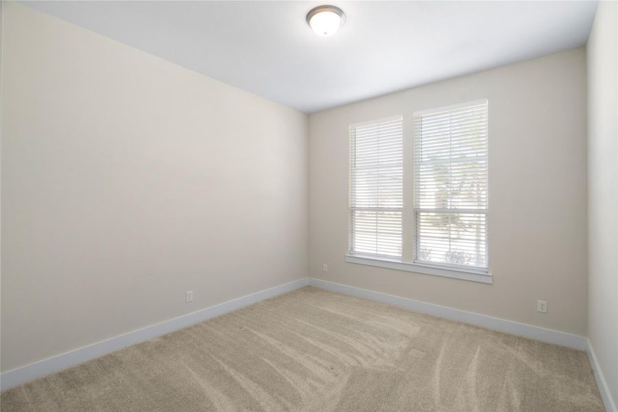 Second downstairs bedroom with an attached full bathroom.