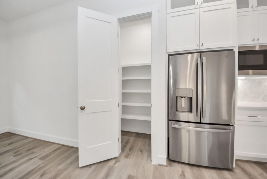 Additional kitchen angle showcasing pantry next to dining room.
